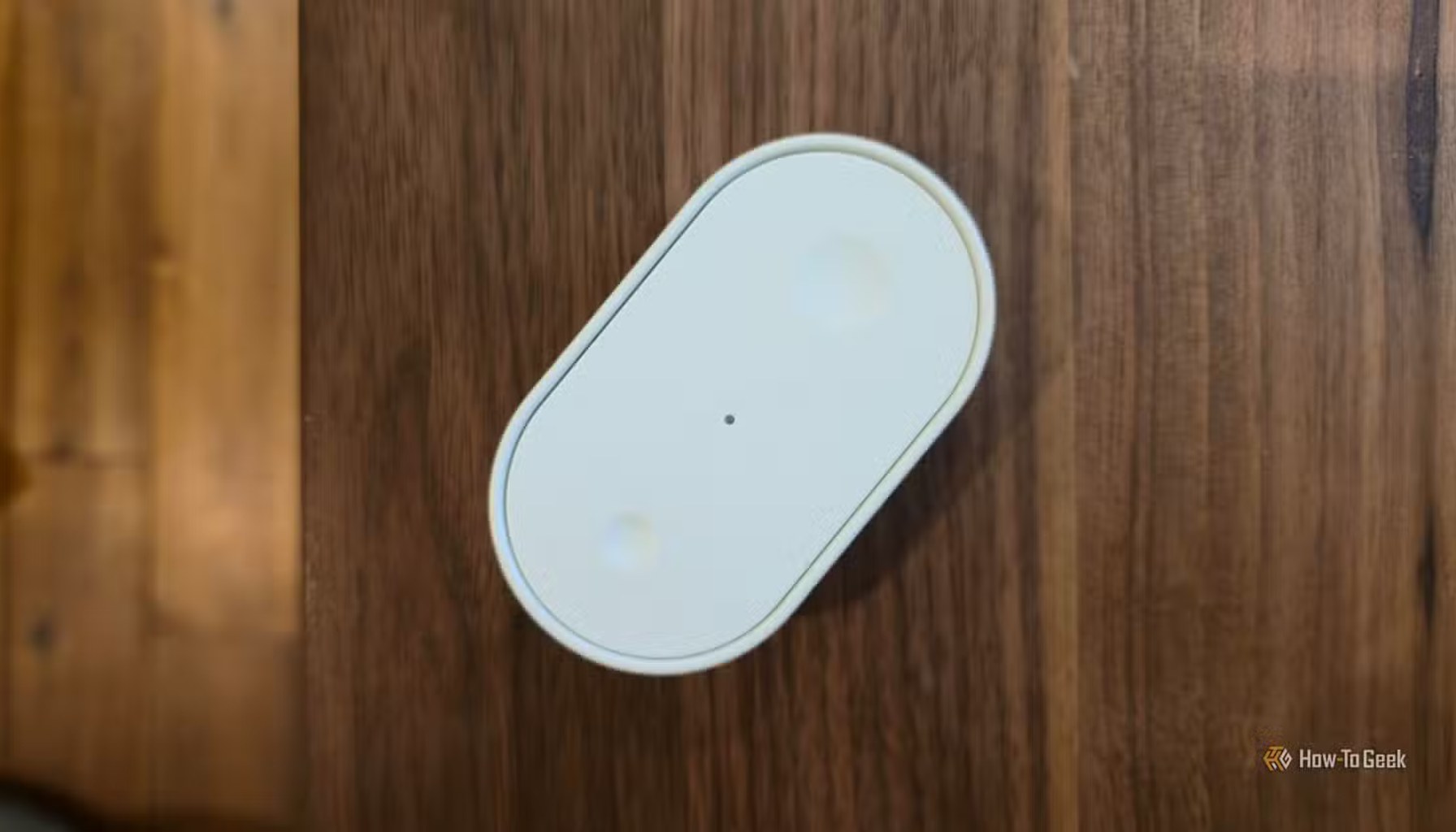 An IKEA BILRESA smart remote on a desk.