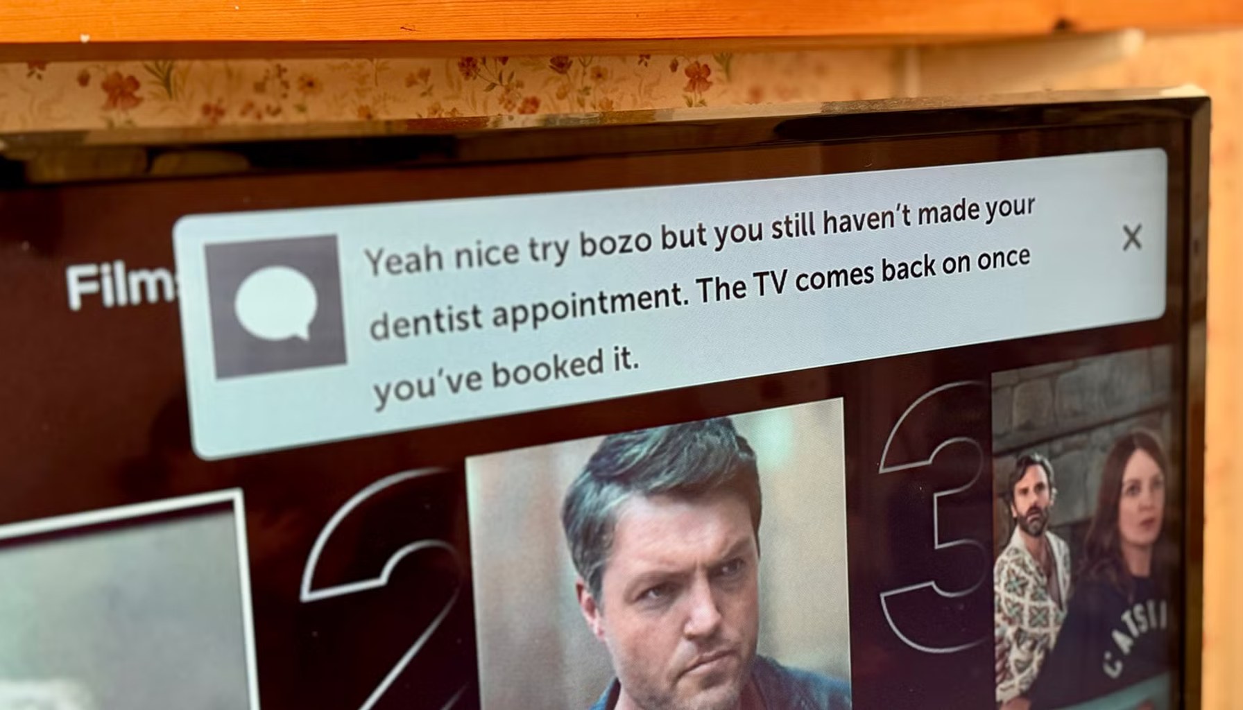 A TV showing a Home Assistant notification saying Yeah nice try bozo but you still havent made your dentist appointment The TV comes back on once youve booked it.-1