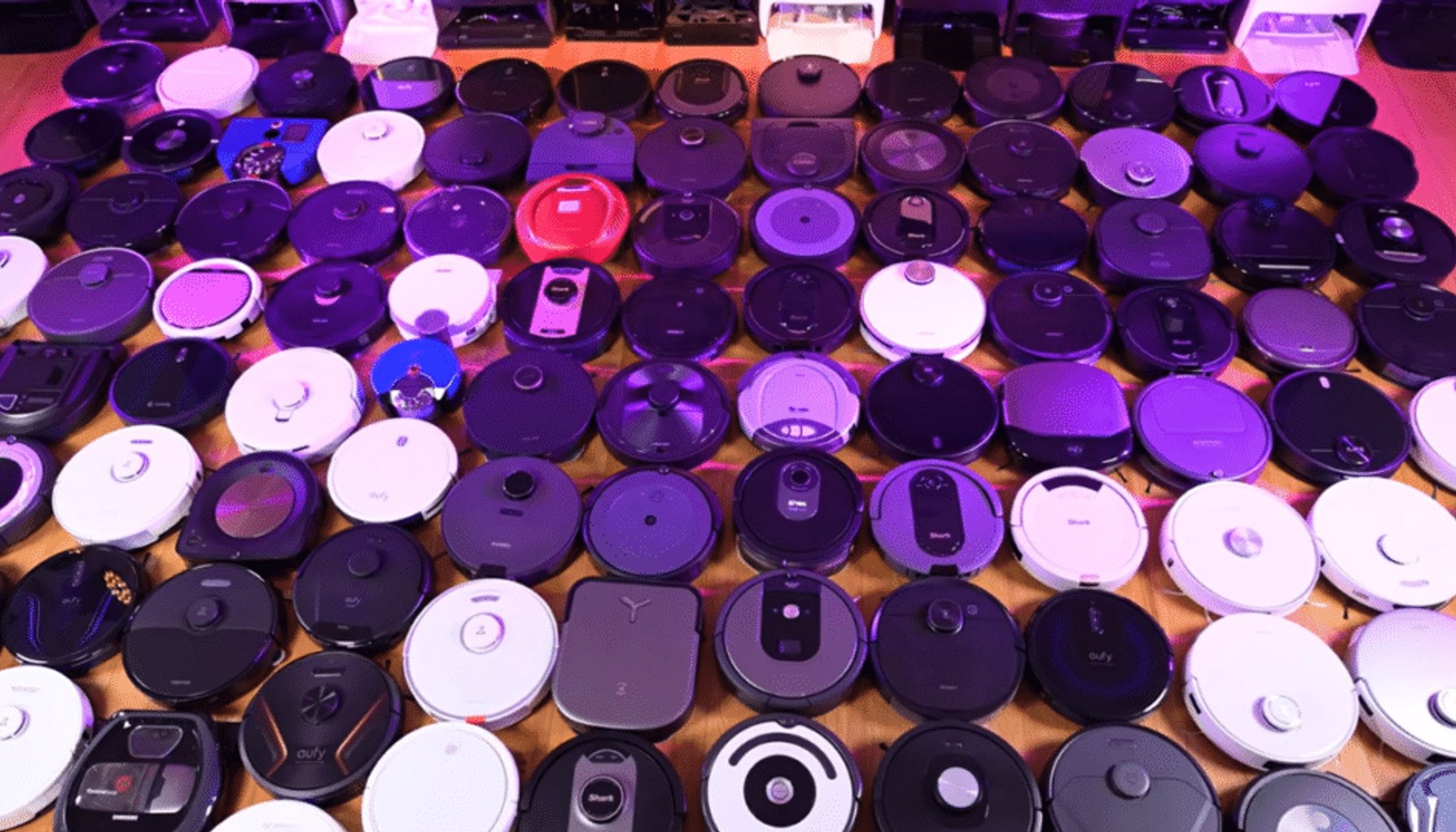 Dozens of robot vacuums from multiple brands displayed together, illustrating the wide range of connected autonomous cleaning robots affected by the FCC's definition of advanced robotic devices.