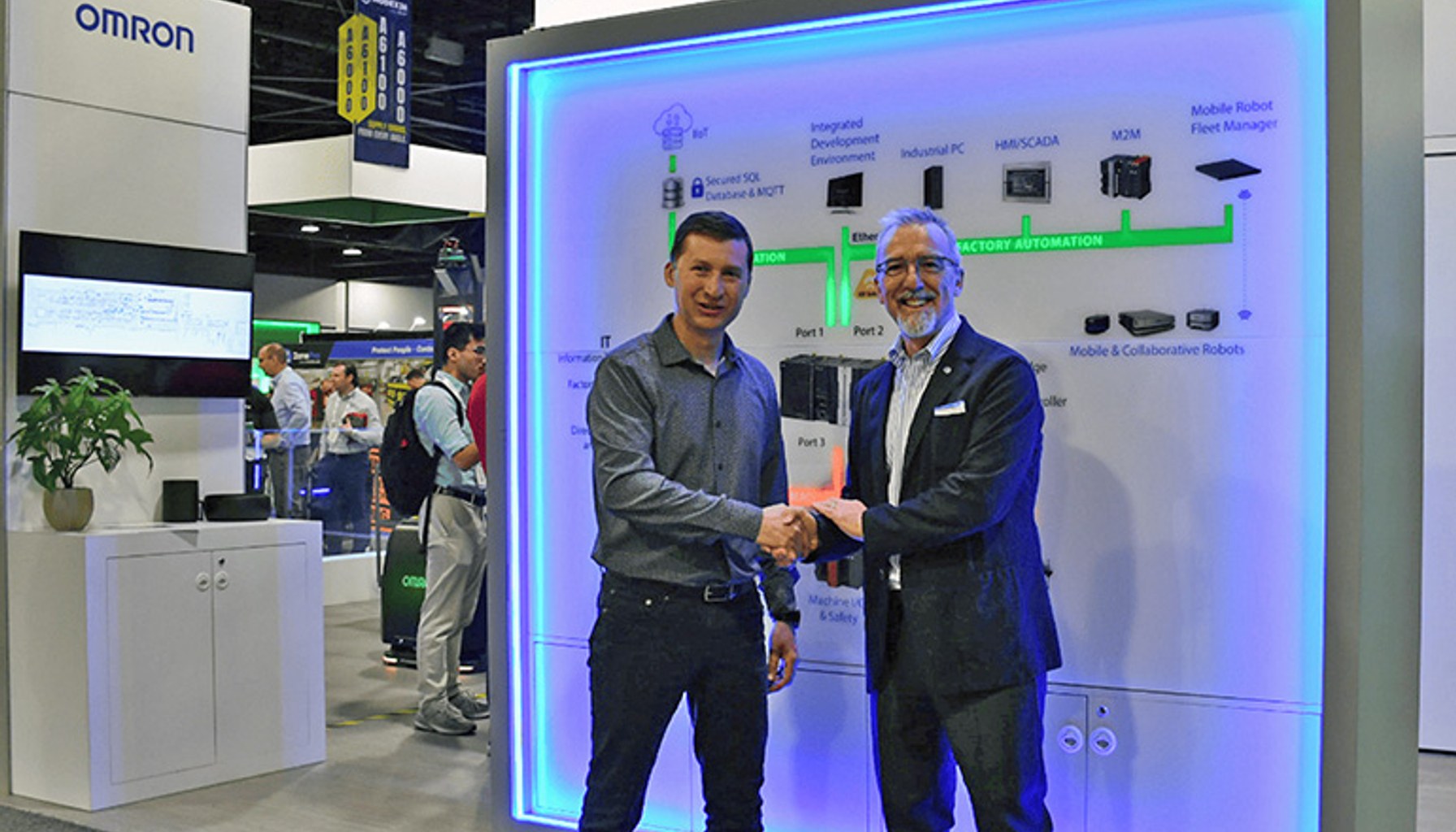 Olivier Welker, CEO of OMRON Robotics, with Pietro Gorlier, CEO of Comau.